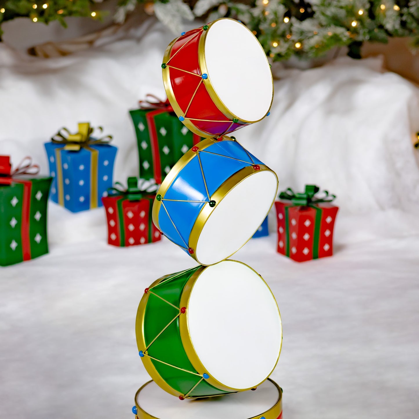 Stack of colorful drums with Christmas presents and decorations in the background