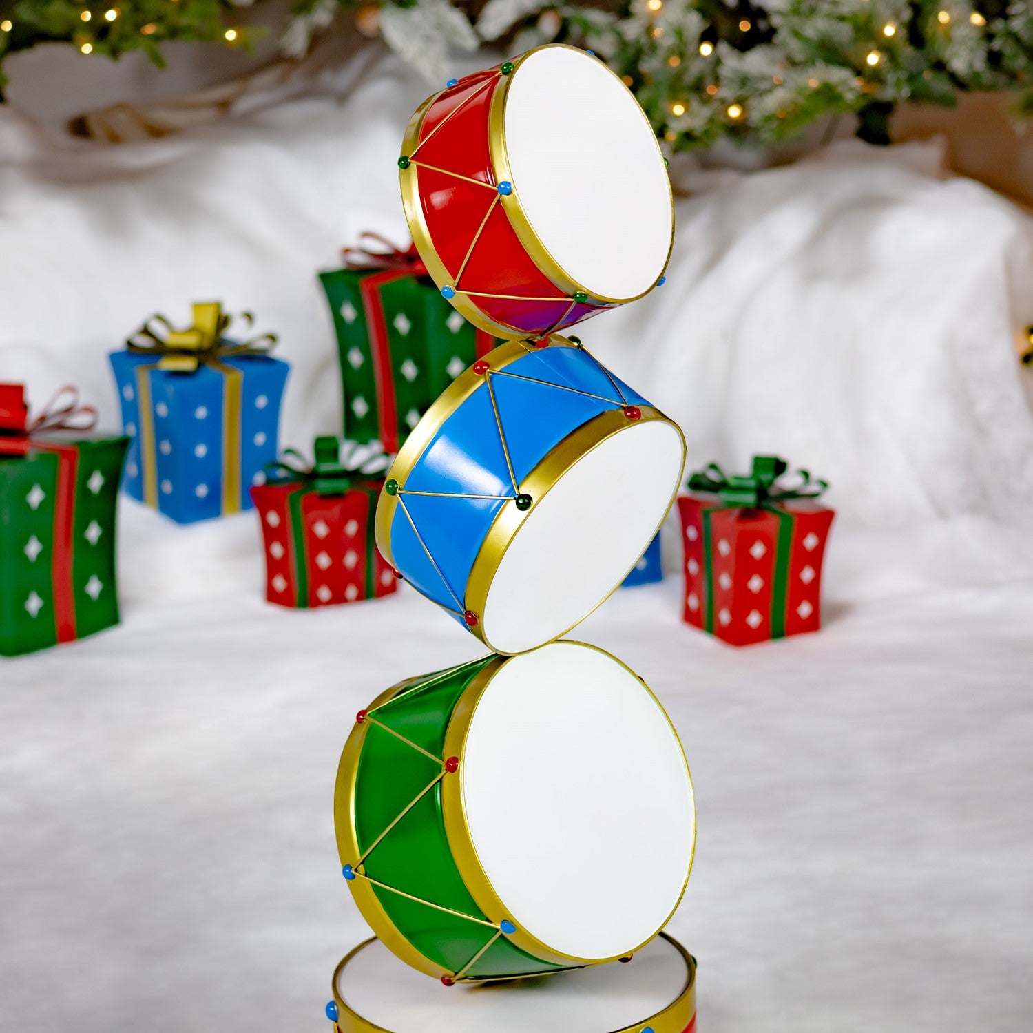 Stack of colorful drums with Christmas presents and decorations in the background