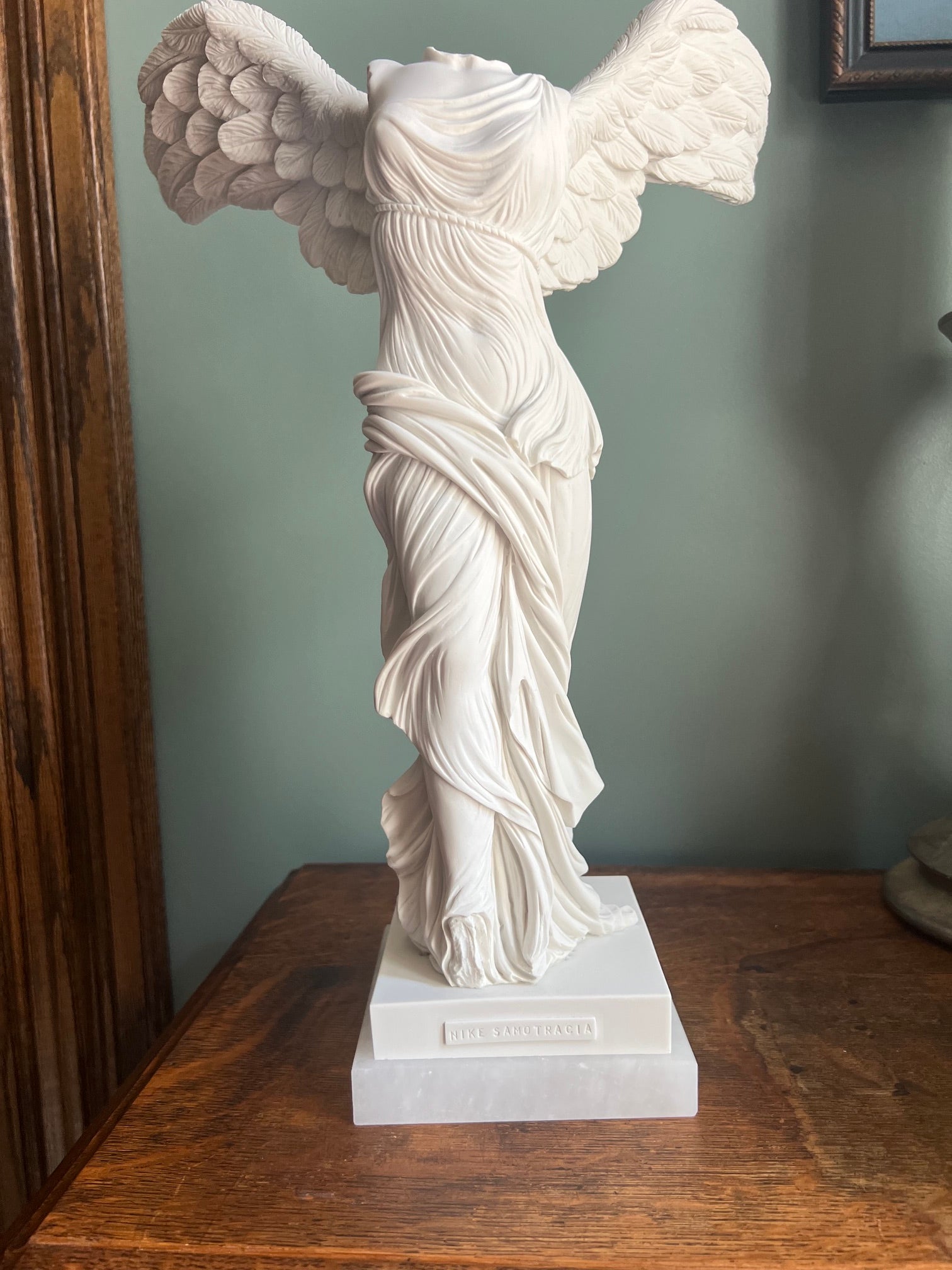 Classical Winged Victory statue mounted on alabaster base