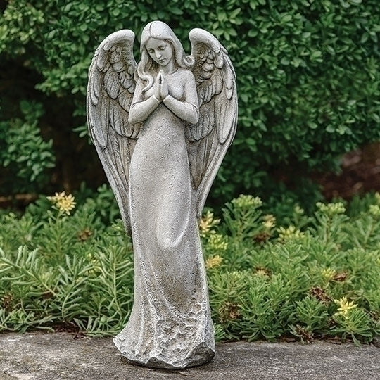 Statue of an angel with outstretched wings in a garden setting contemporary