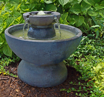 Round Copa Garden Decorative outdoor water fountain with greenery in the background