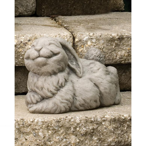 Sculpture of a whimsical statue of a bunny rabbit smiling made of cement outdoor garden statuary
