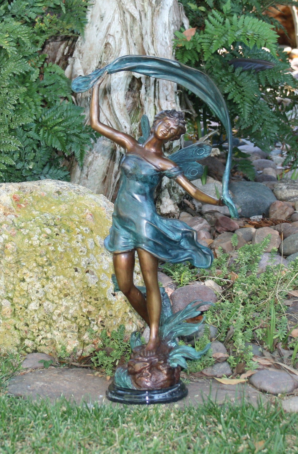 fairy statue with marble base dancing in the wind blown with scarf in hands