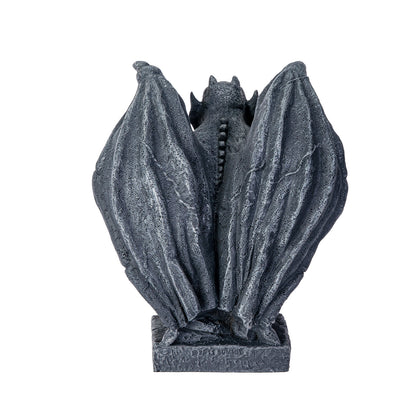 Decorative stone gargoyle sculpture on a white background back view of statue