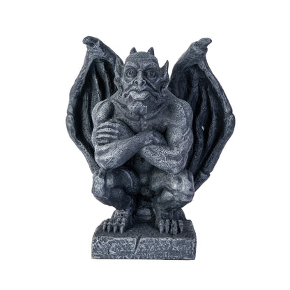 Gargoyle statue with wings spread on a white background  arms folded