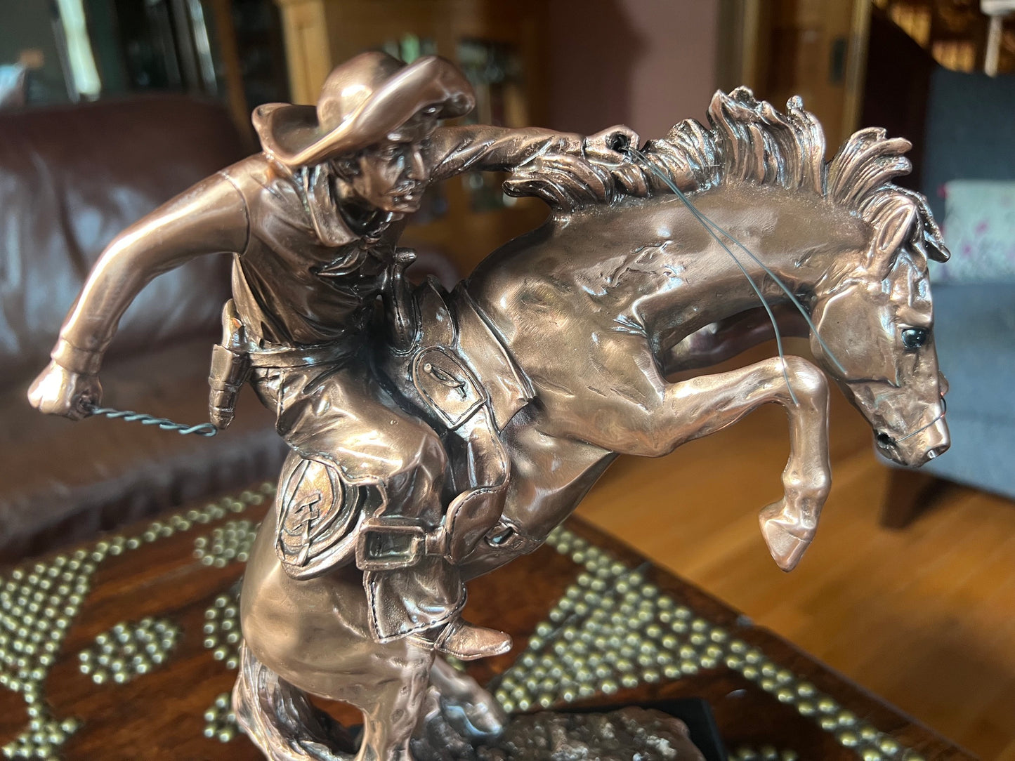 Detailed cowboy breaking a wild horse Western sculpture
