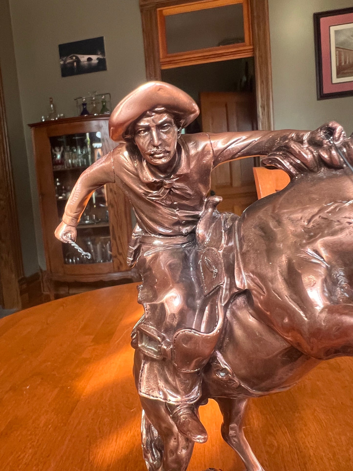 Detailed cowboy breaking a wild horse Western sculpture face and clothing