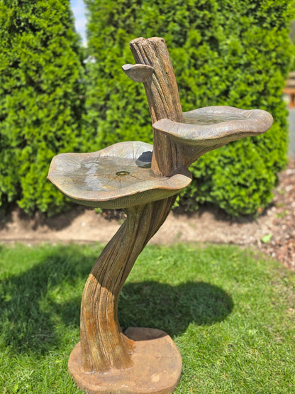 Decorative outdoor birdbath with lily-shaped bowls