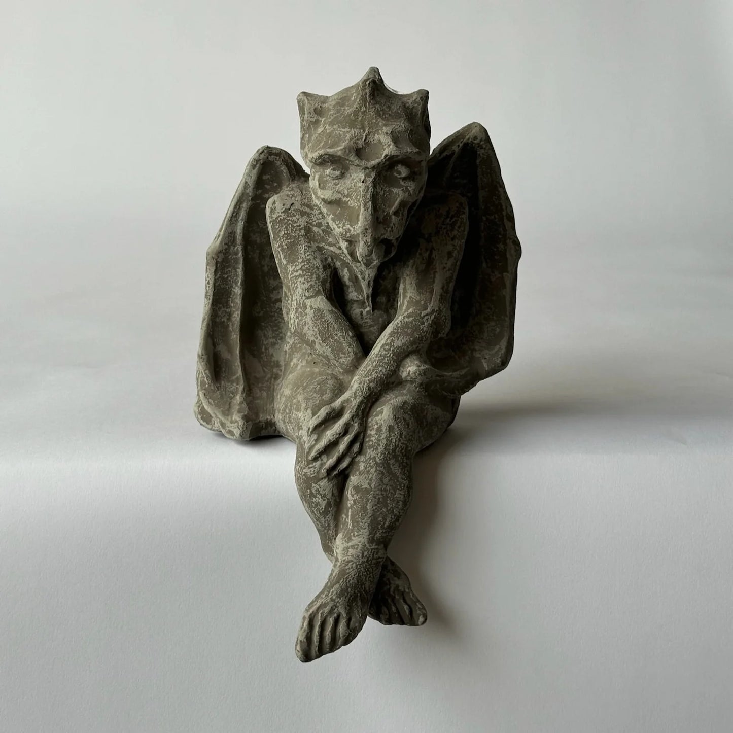 Stone gargoyle sculpture on a plain background Small Drysdale Gargoyle adds playful Notre Dame charm and protective presence