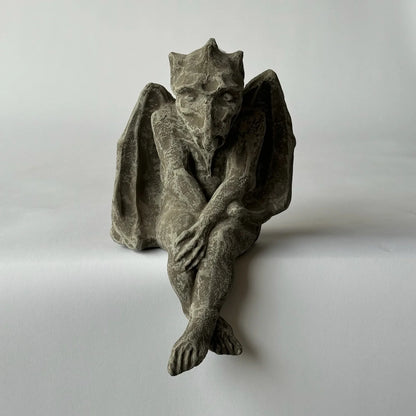 Stone gargoyle sculpture on a plain background Small Drysdale Gargoyle adds playful Notre Dame charm and protective presence