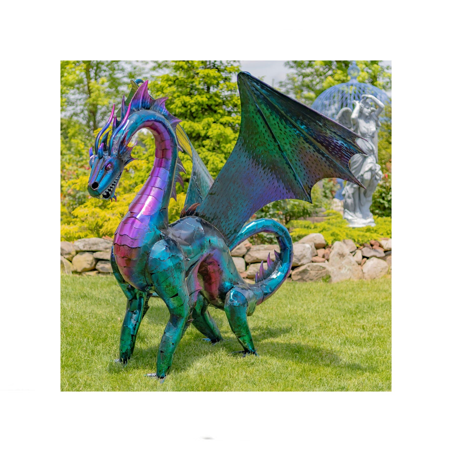 Colorful dragon sculpture in a garden setting with trees and rocks in the background