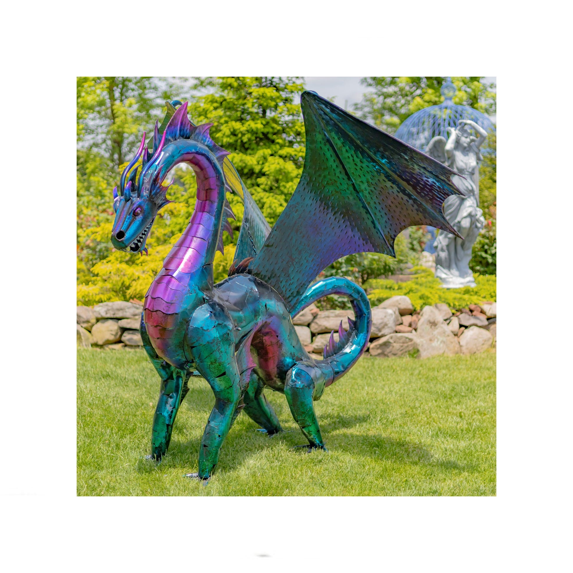 Colorful dragon sculpture in a garden setting with trees and rocks in the background