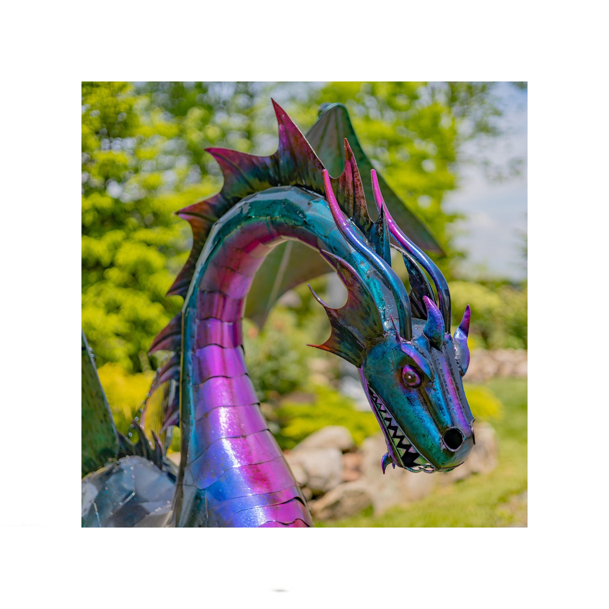 Colorful dragon sculpture in a garden setting close up of head  statue