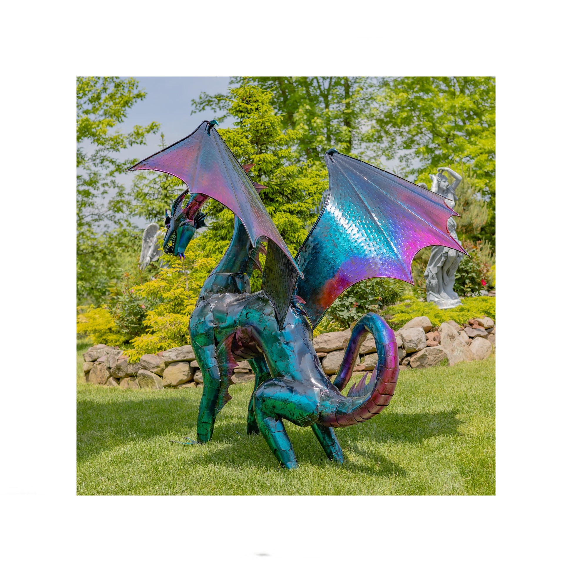 Colorful dragon sculpture in a garden setting with trees and rocks in the background back view