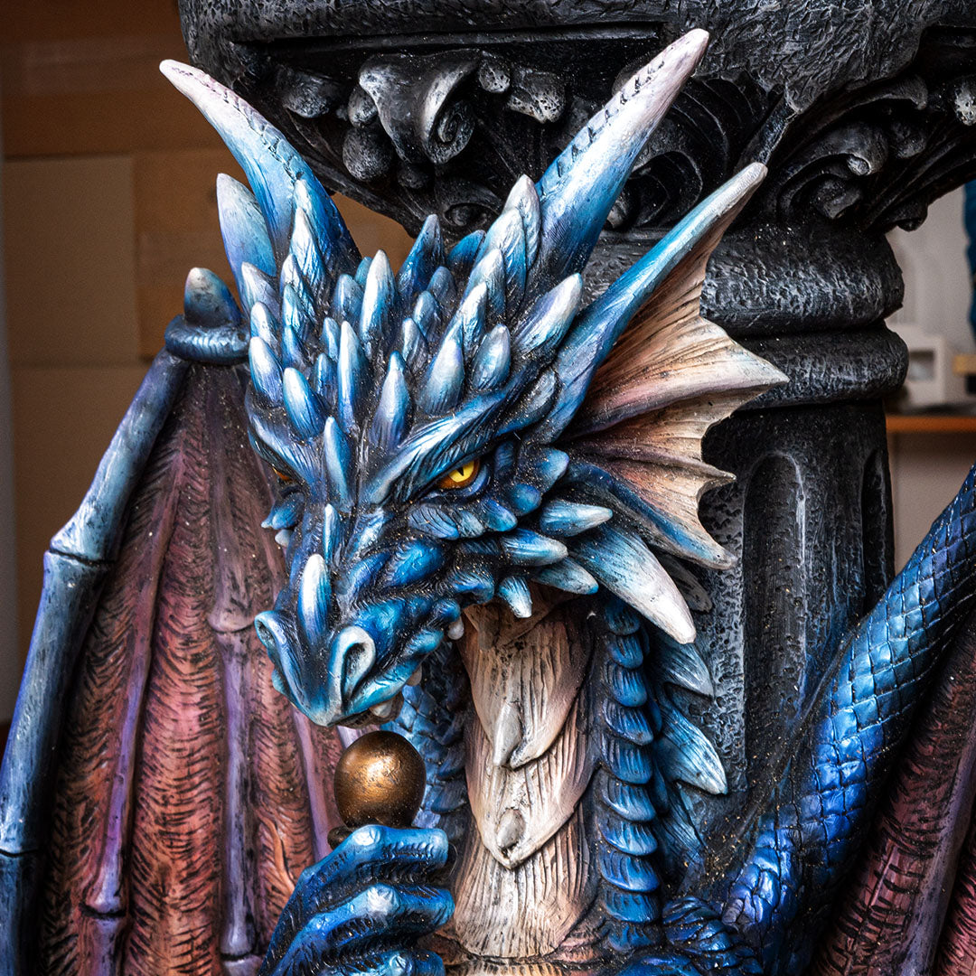 Close up of face of Dragon holding sword table base with glass top
