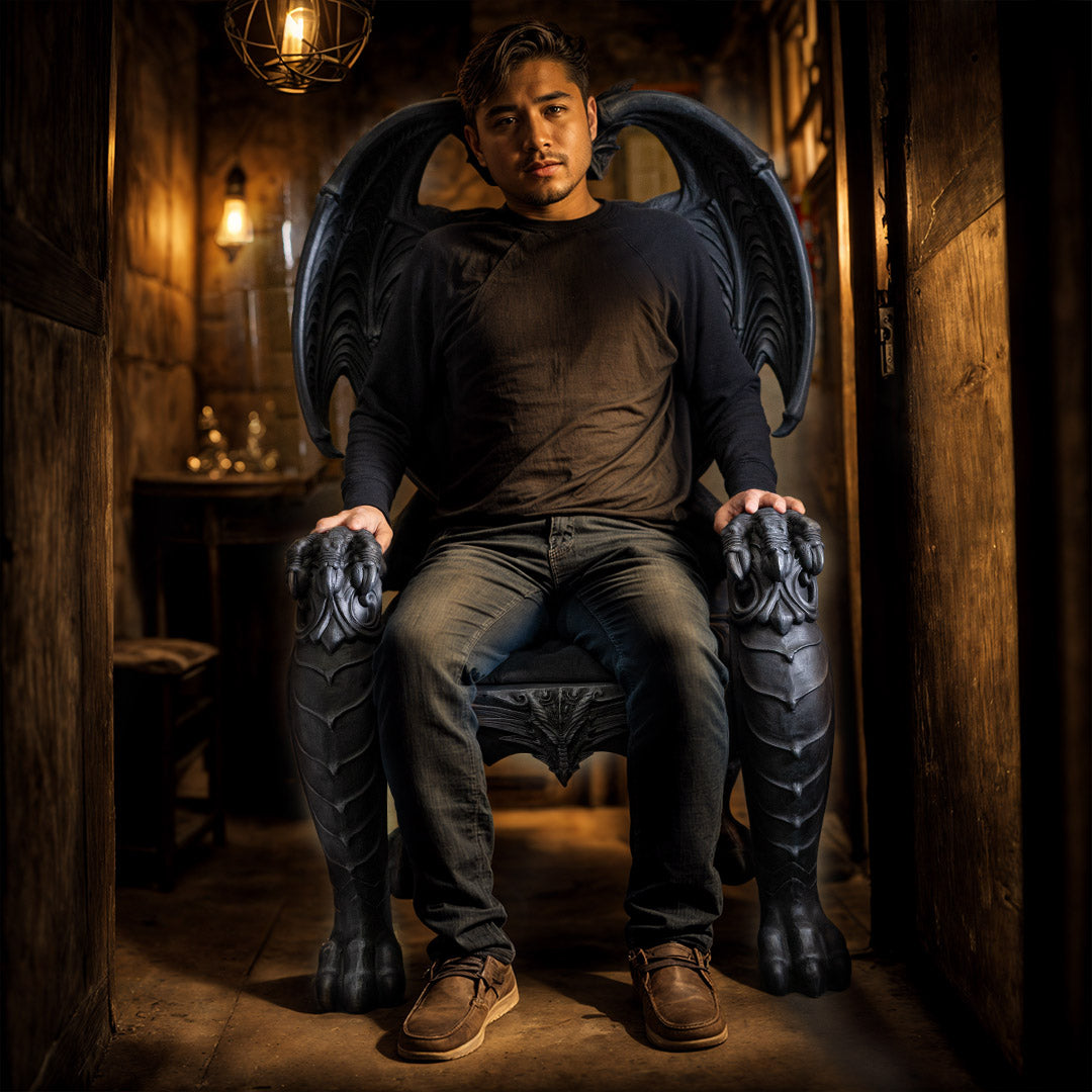 Man sitting on a chair with dragon-like armrests and footrests in a dimly lit room.