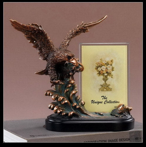 The Waves of Freedom Eagle Picture Frame Sculpture captures the breathtaking moment of an American eagle descending upon rolling waves, poised to claim its prey.