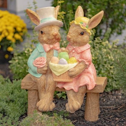 Hand-painted bunny couple sitting on a bench holding a basket of Easter eggs