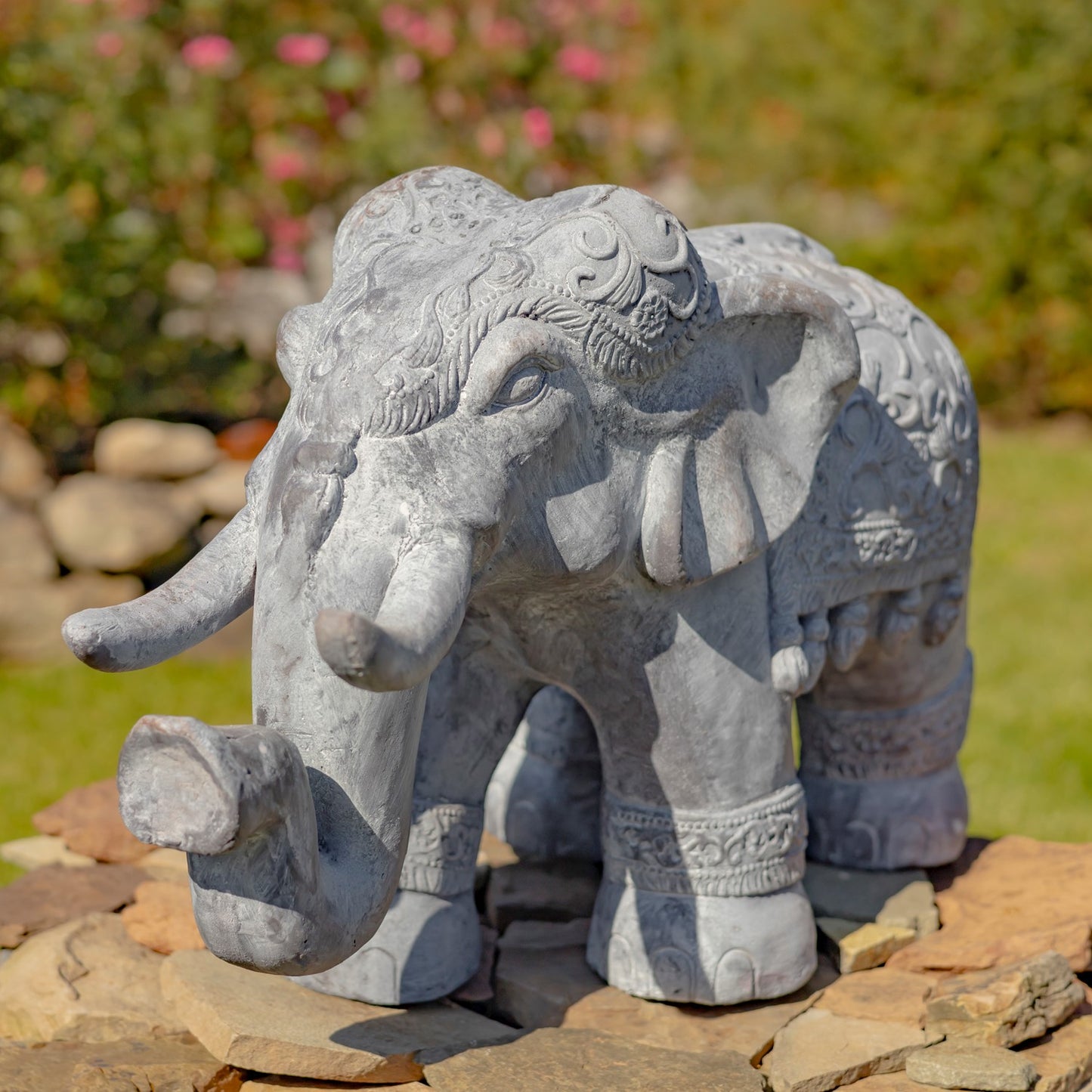 Side view decorative elephant garden statue with ornate carved detailing