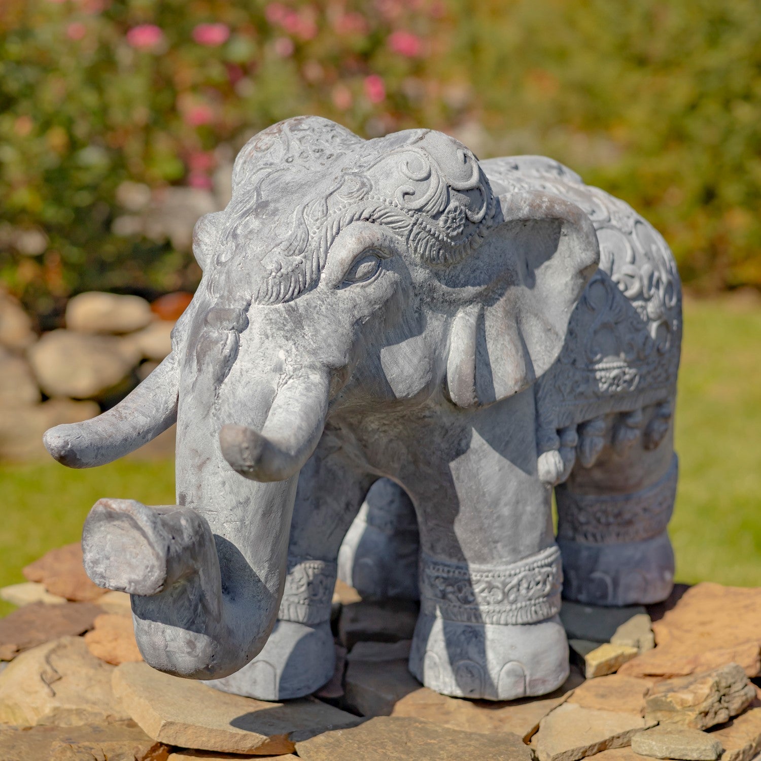 Side view decorative elephant garden statue with ornate carved detailing