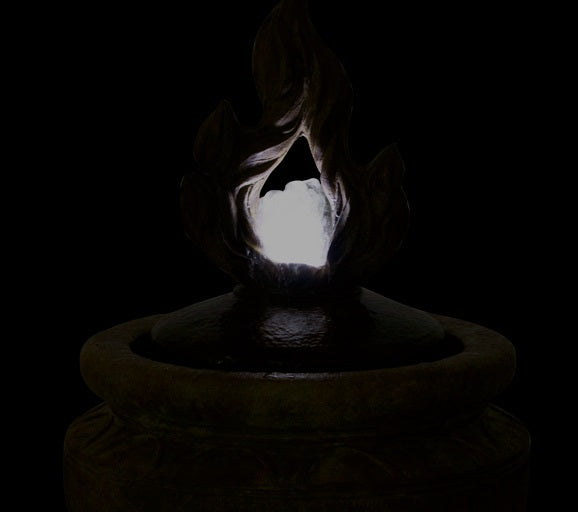 Inspirational flame fountain for prayer or meditation space night time view of sculpture