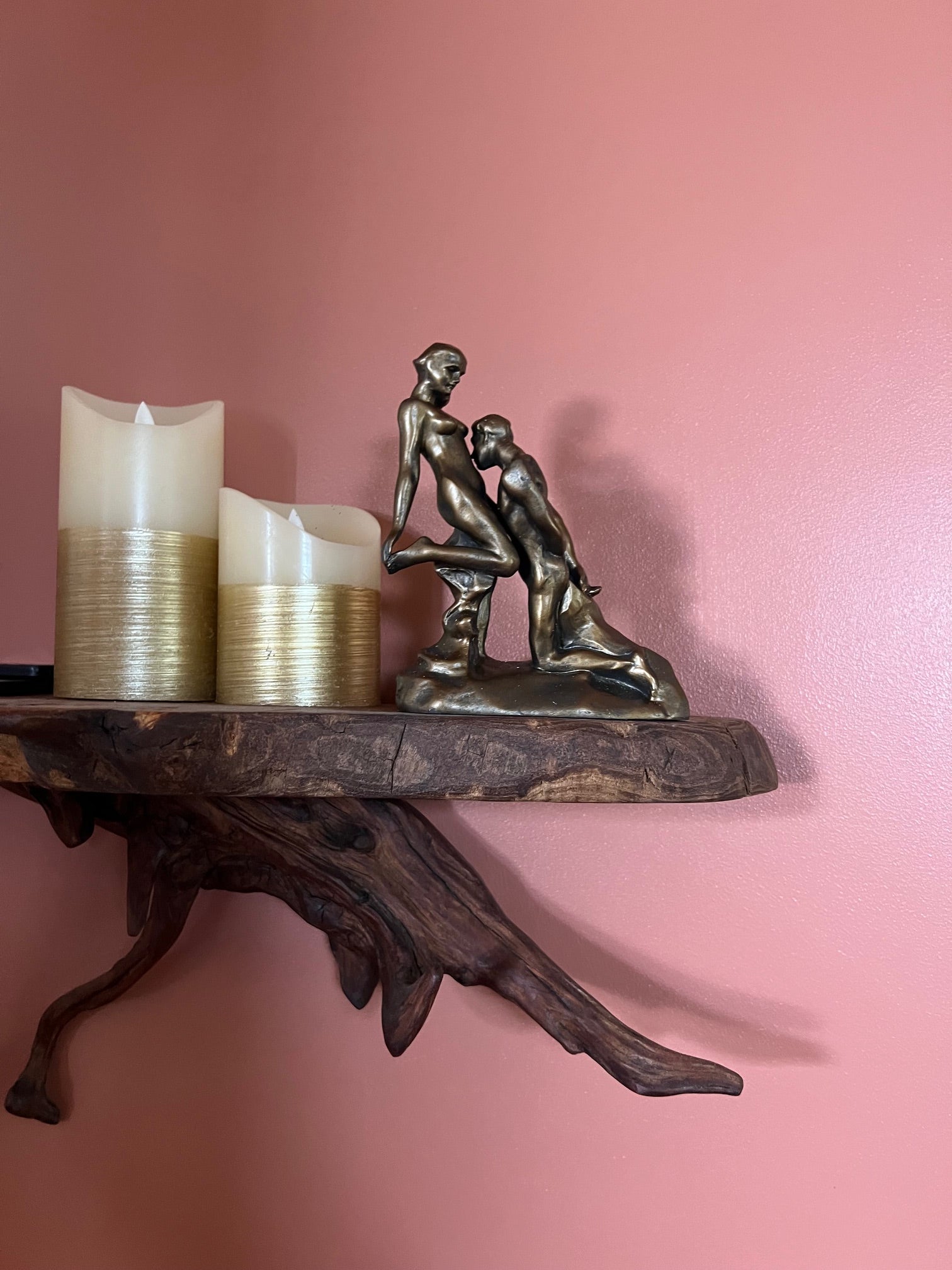 The Eternal Idol Sculpture by Auguste Rodin next to candles to show size