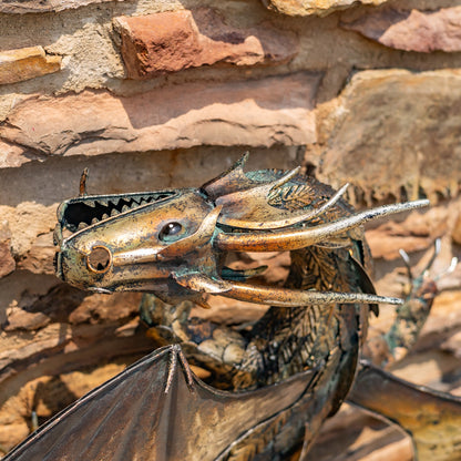 Horned Guardian Serpent wall dragon sculpture with coiled body and spread wings mounted on stone wall