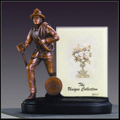 Bronze statue of a figure holding an axe on a black base picture frame sculpture for firefighters
