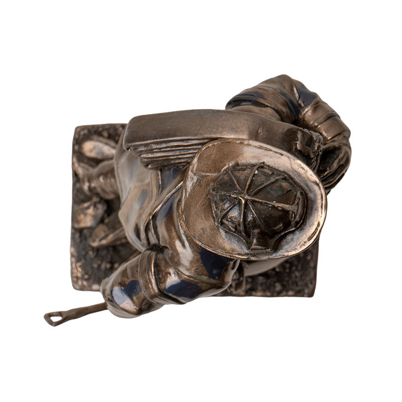 firefighter carrying hose statue emergency responder art top view of sculpture