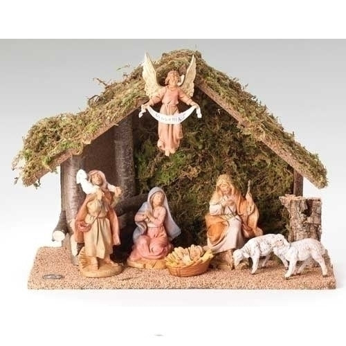 Nativity scene with figures and a stable on a white background