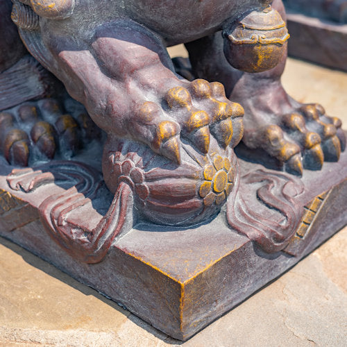 close up of Chinese ball Foo Dogs garden statues also known as Imperial Guardian Lions or Shish symbolized protection power and prosperity