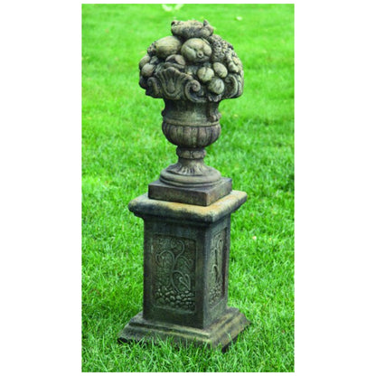 Stacked fruit sculpture with detailed apples, grapes, and pears forming a decorative garden finial.