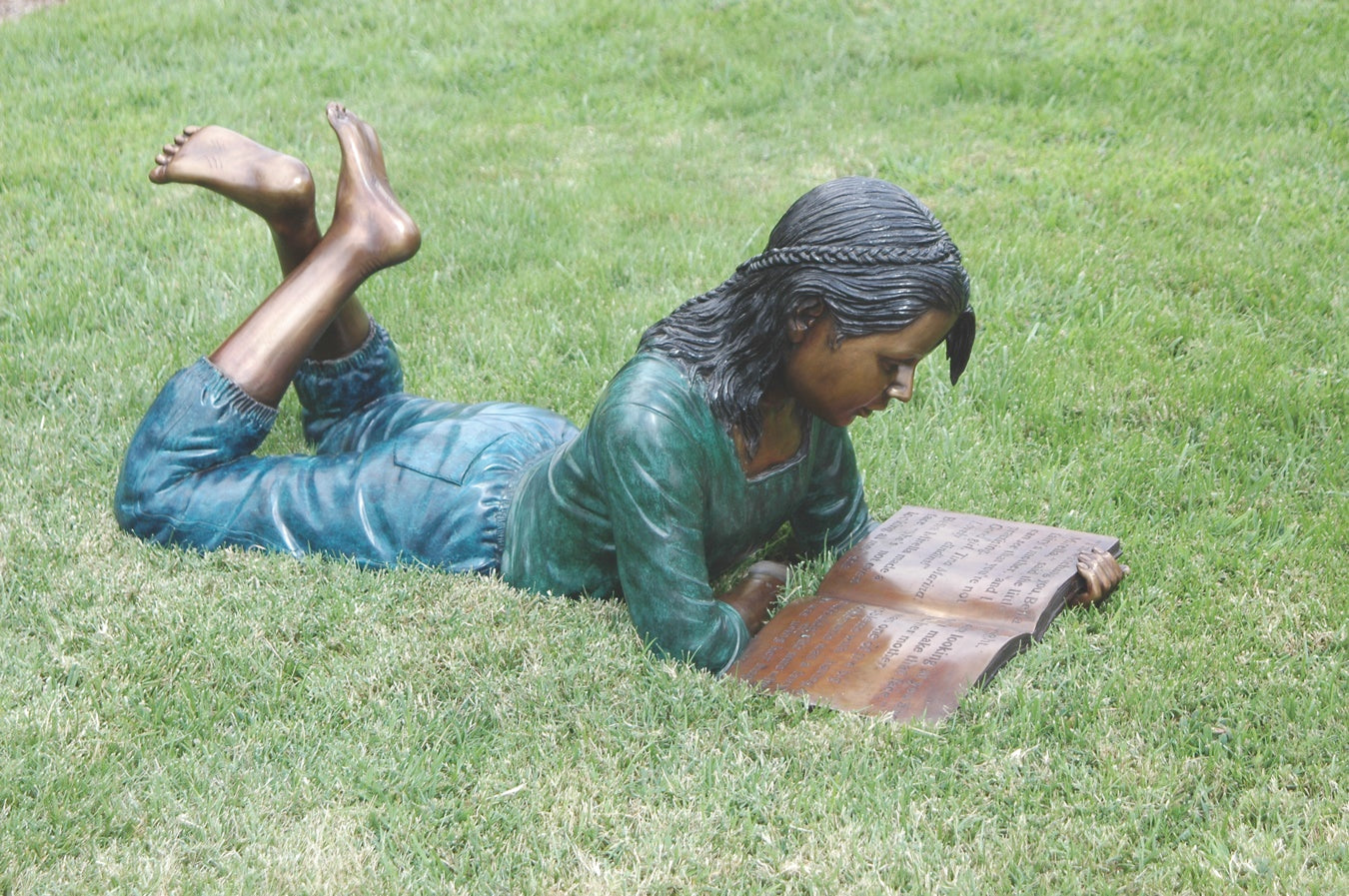Girl lying down reading book bronze garden sculpture