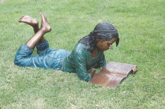 Girl lying down reading book bronze garden sculpture