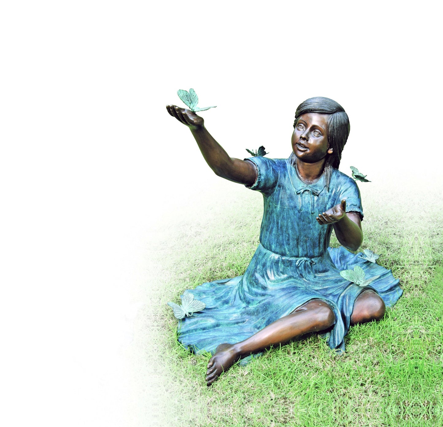 Butterfly Wishes Bronze Girl Statue seated in garden with butterflies