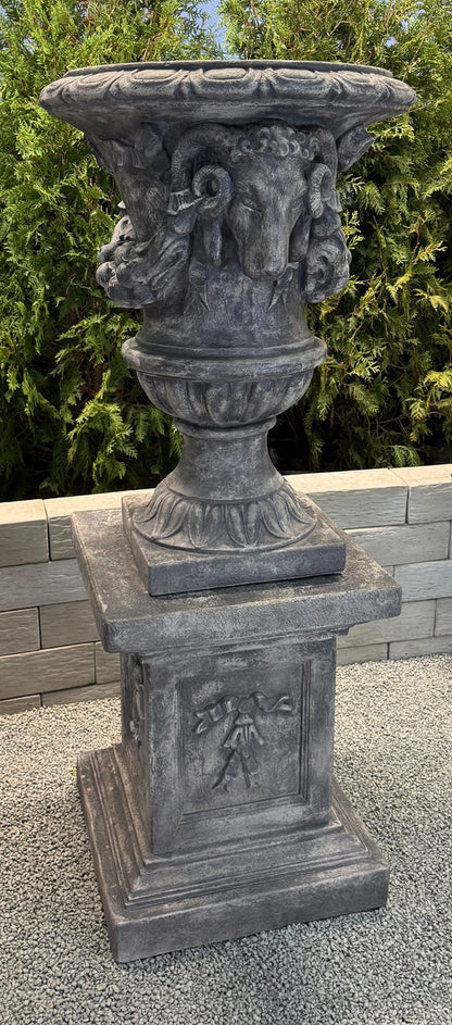 grand ram head estate garden urn on pedestal shown on column in courtyard