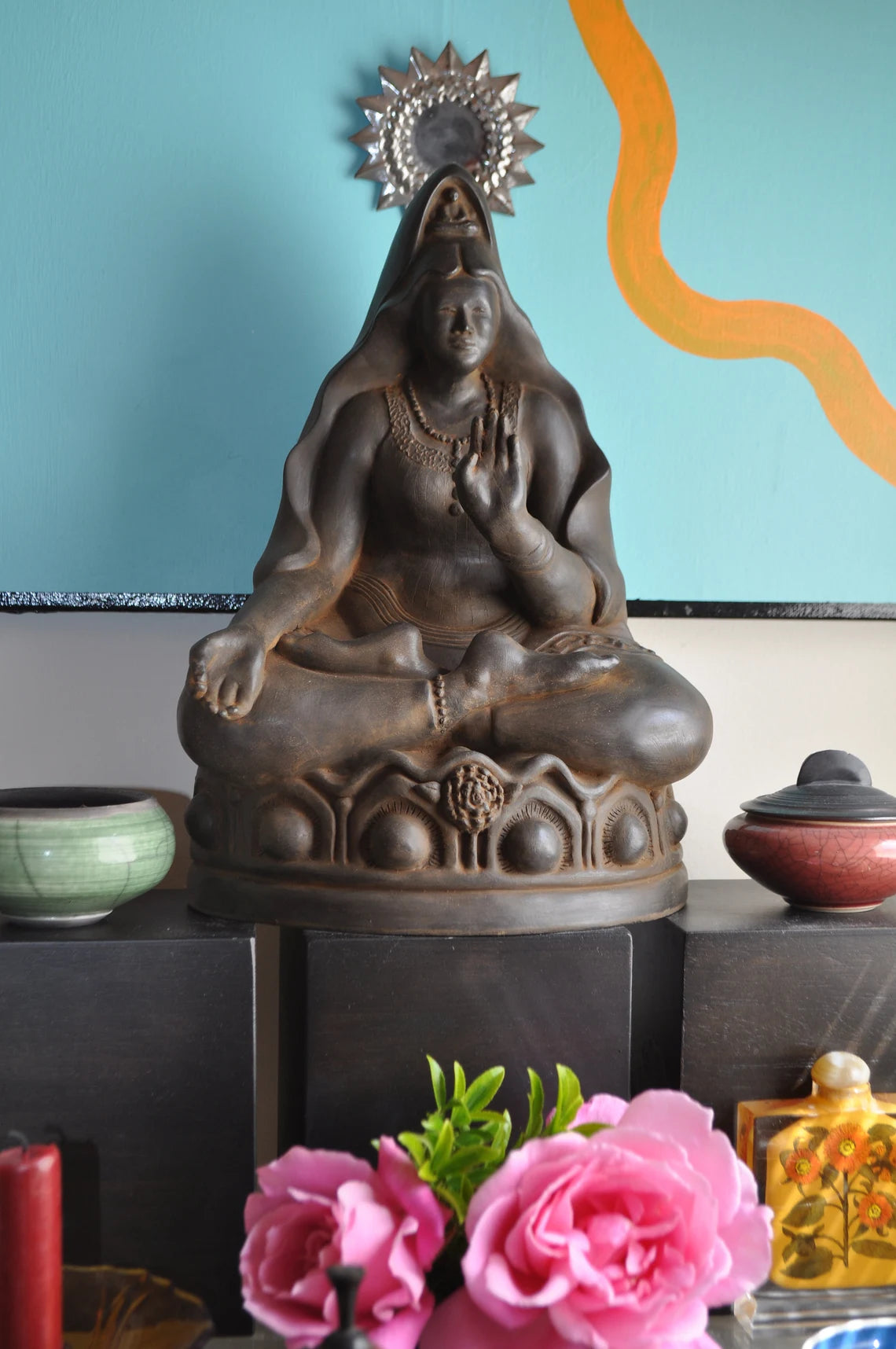 Graceful and contemplative, this Kuan Yin sculpture by Sigrid Herr captures the serene presence of the revered Goddess of Mercy