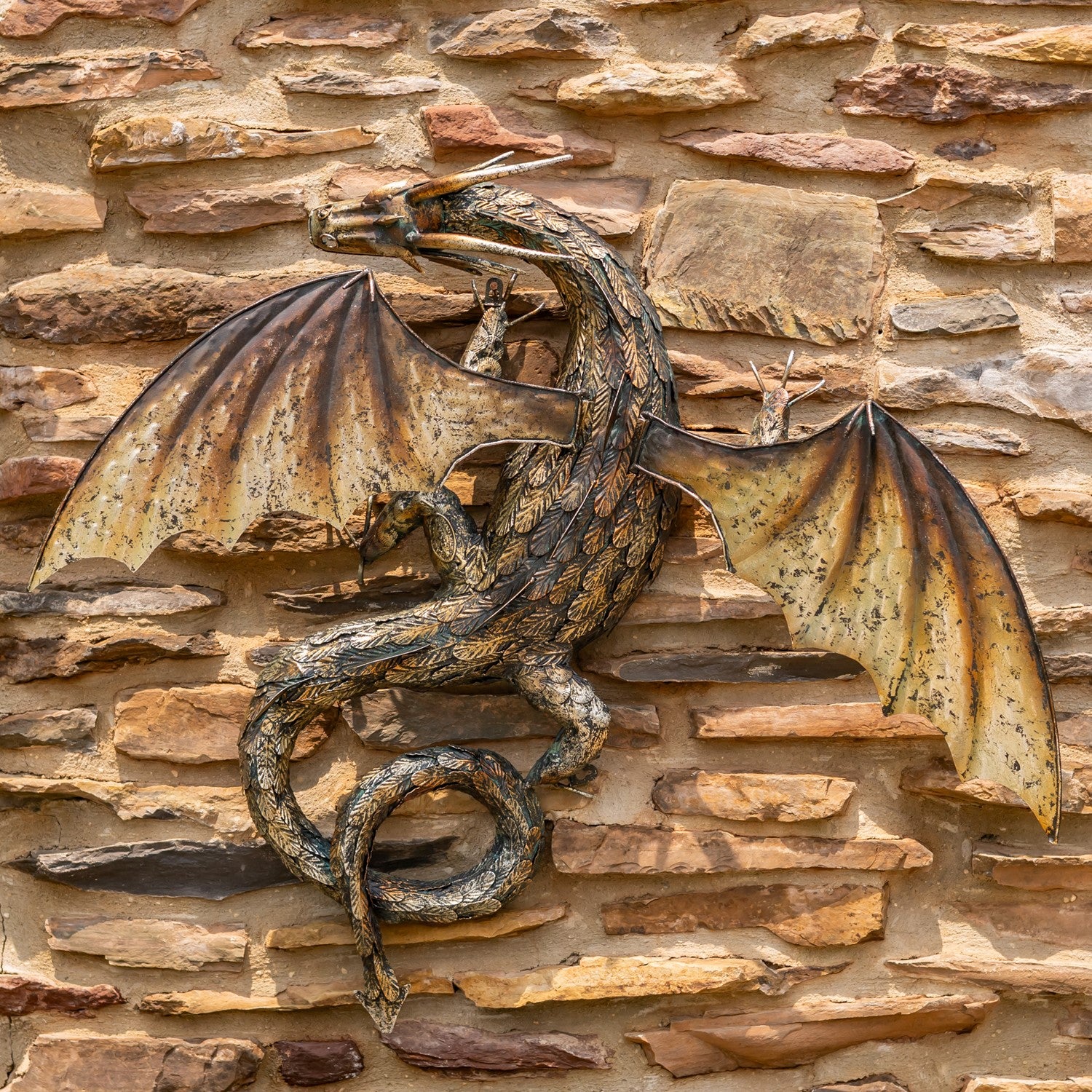 Guardian Serpent wall dragon sculpture with coiled body and spread wings mounted on stone wall