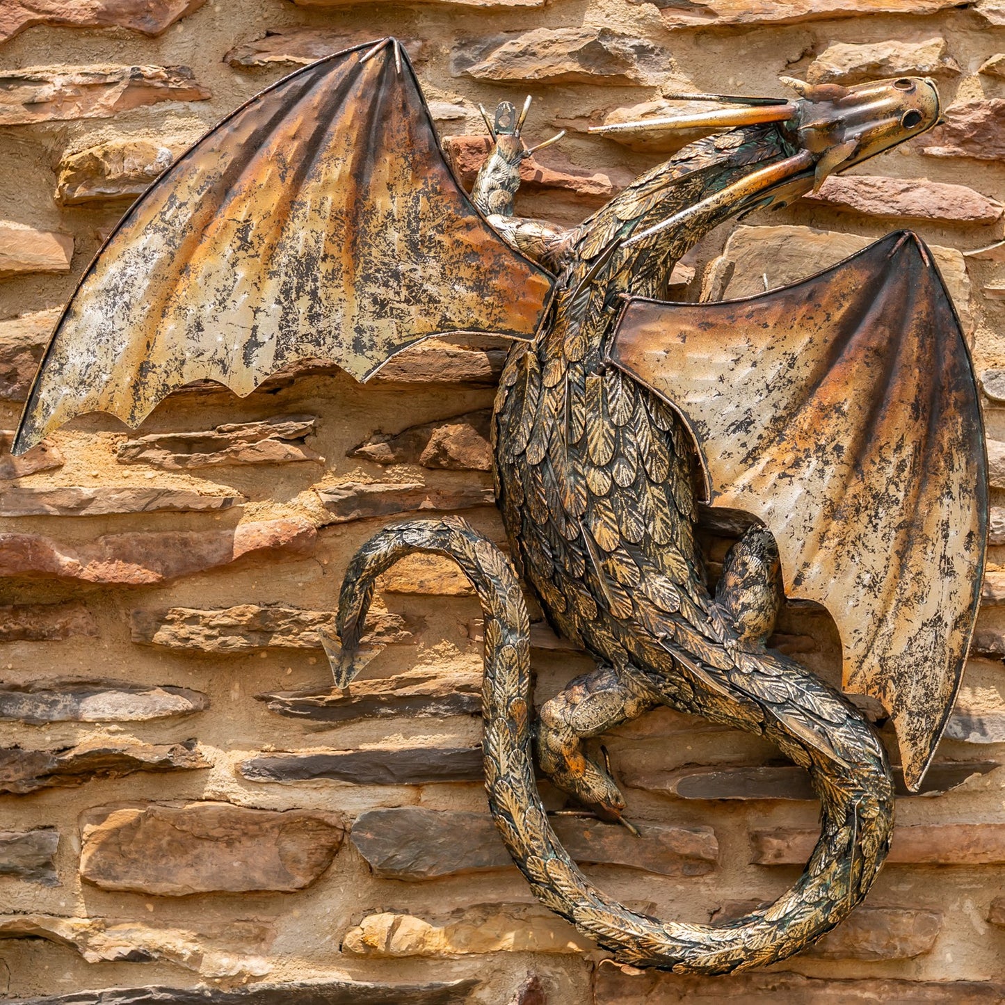 Guardian Serpent wall dragon sculpture with coiled body and spread wings mounted on stone wall