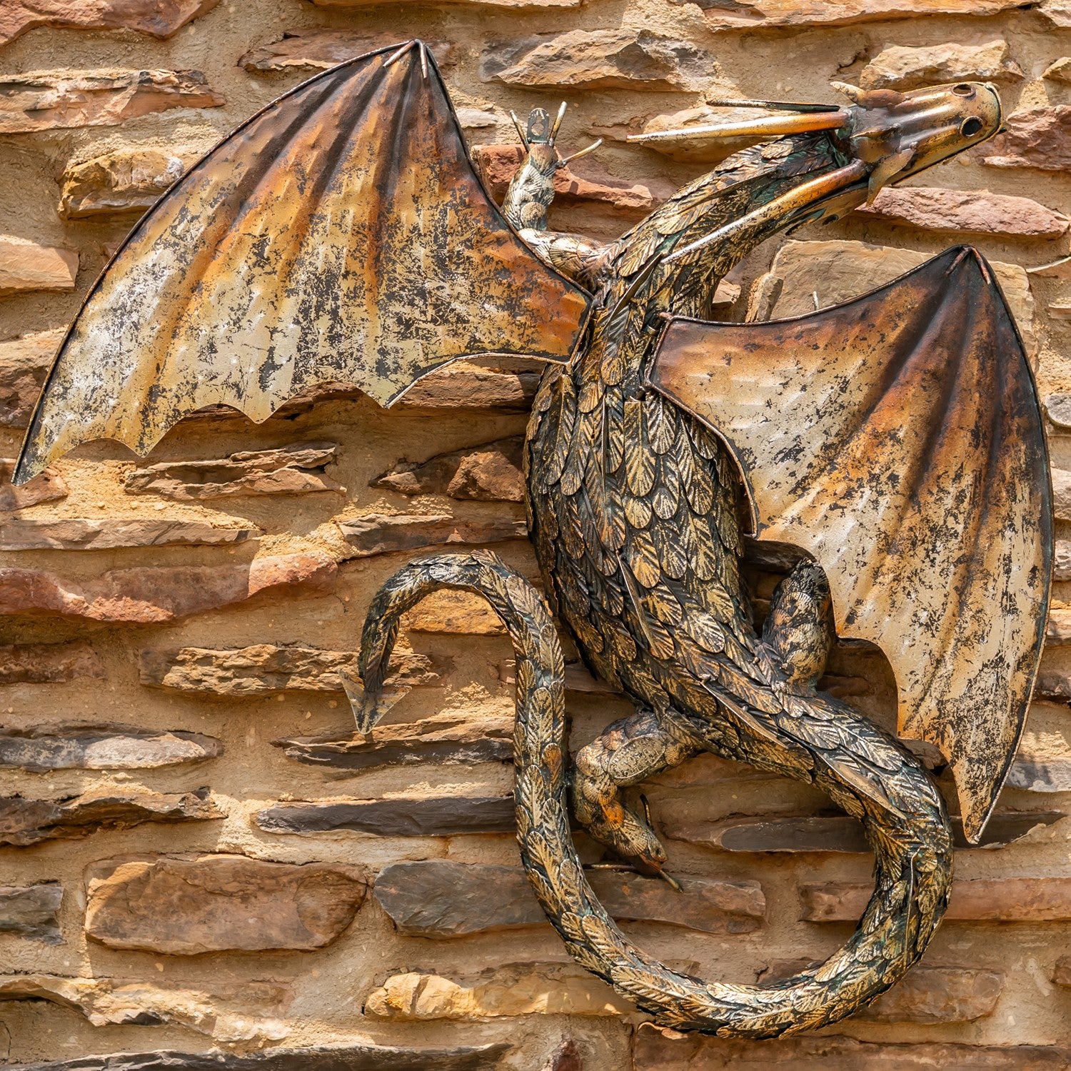 Guardian Serpent wall dragon sculpture with coiled body and spread wings mounted on stone wall