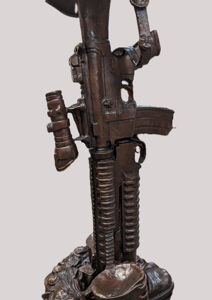Bronze sculpture of a gun with intricate details on a white background Battle Boots Cross