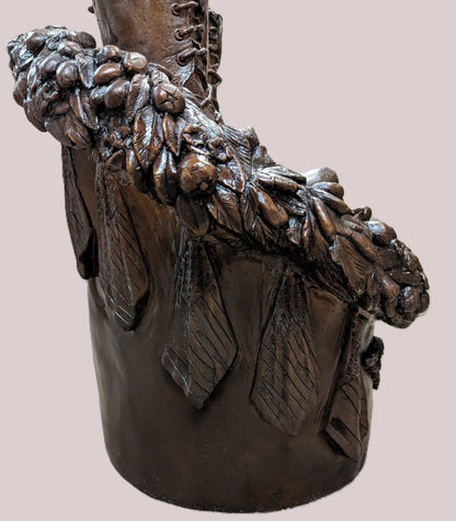 Bronze boot with decorative elements on a pink background Guardian of Freedom Bronze Battle Cross Sculpture