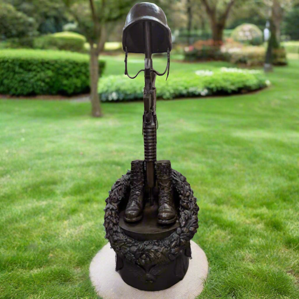 Guardian of Freedom Bronze Battle Cross Sculpture with helmet, rifle, and boots on display.