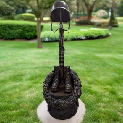 Guardian of Freedom Bronze Battle Cross Sculpture with helmet, rifle, and boots on display.