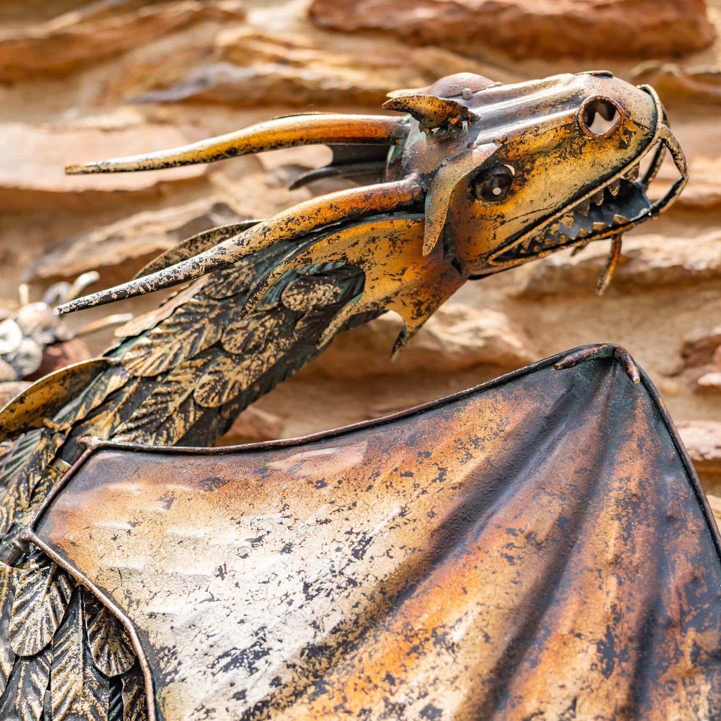 Dramatic metal wall dragon sculpture with serpent form close up of head