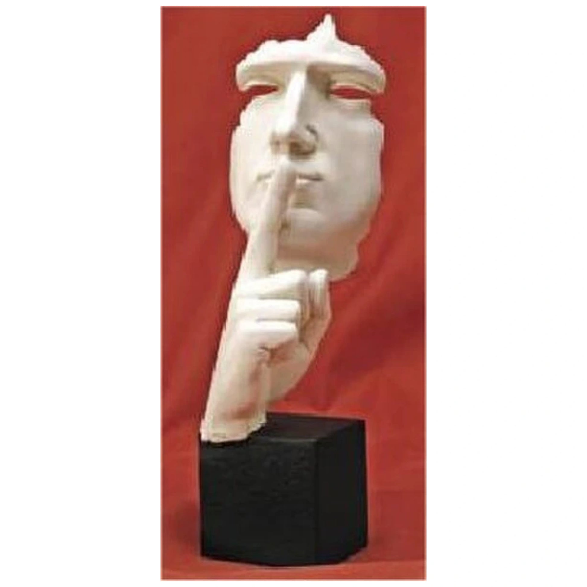 Abstract statue of a finger and face shushing, white statue on a red background. 
