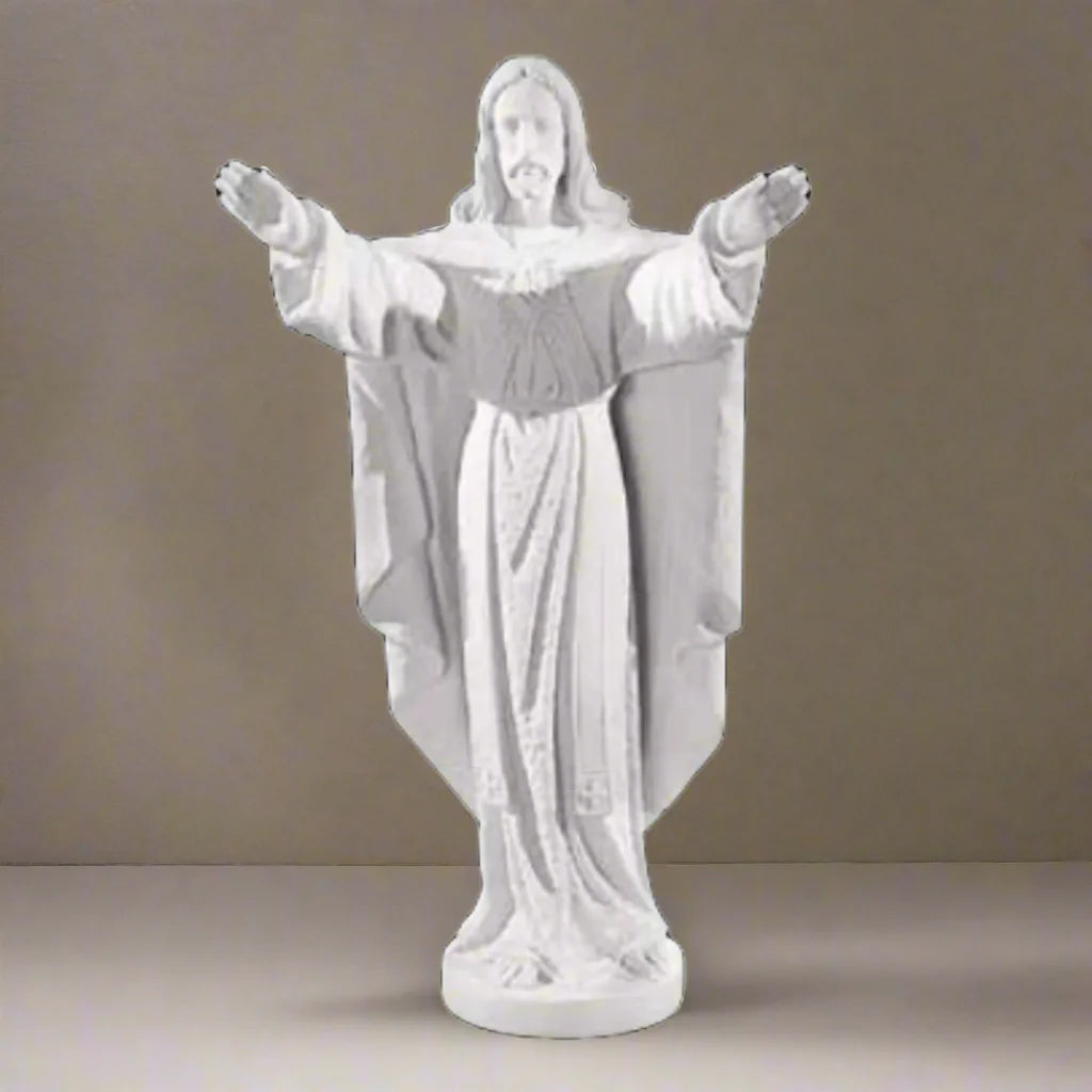 Collector-grade marble Jesus sculpture, life-size figure of Christ in blessing pose - White marble sculpture on a light brown background.