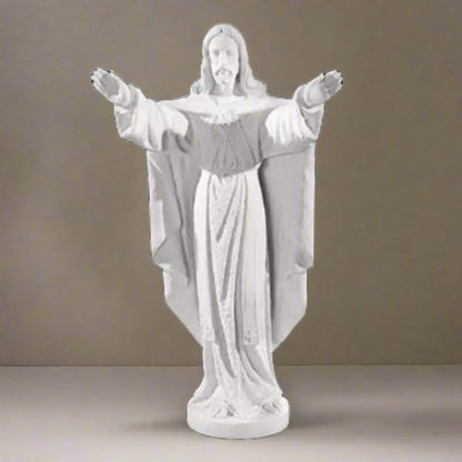 Collector-grade marble Jesus sculpture, life-size figure of Christ in blessing pose - White marble sculpture on a light brown background.