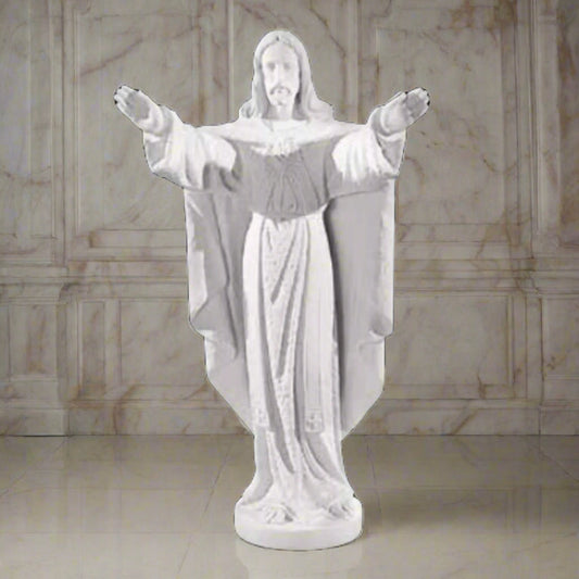 Collector-grade marble Jesus sculpture, life-size figure of Christ in blessing pose - White marble sculpture on a light brown background.