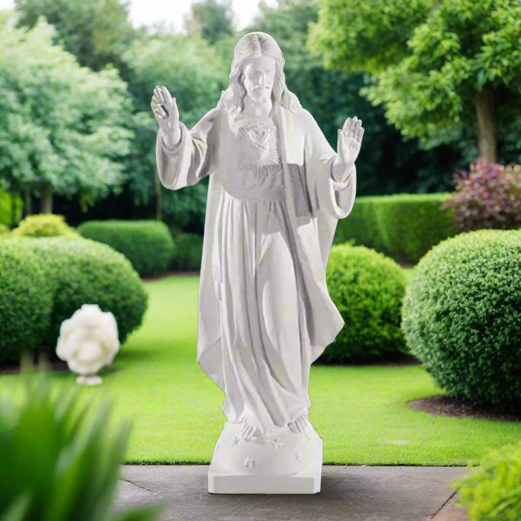 32-inch Sacred Heart of Jesus statue in Italian marble, displayed in a peaceful outdoor setting with manicured greenery and soft lighting